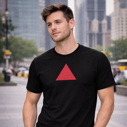 Model wearing a black t-shirt with a red triangle logo walking on a city street.