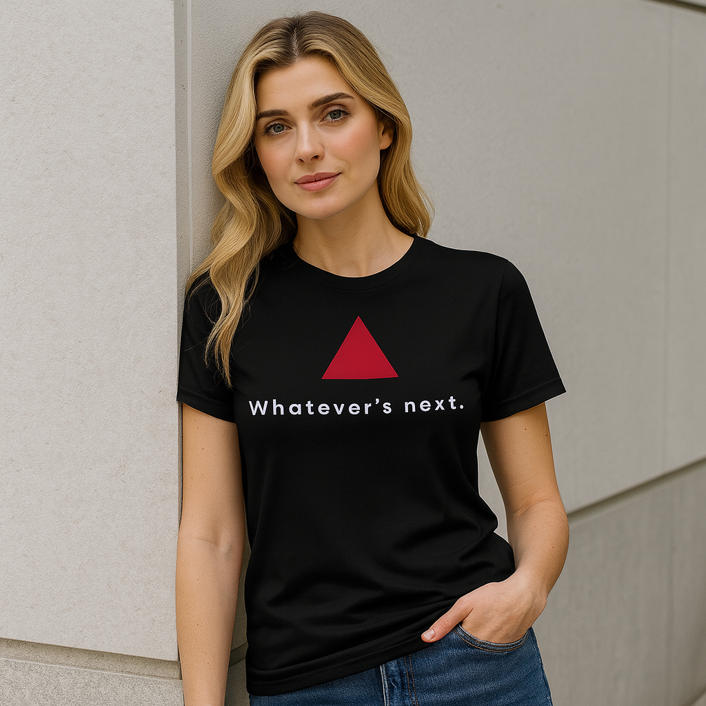 Model wearing a minimalist black t-shirt designed by STEJEX with a red triangle and text, outdoors.
