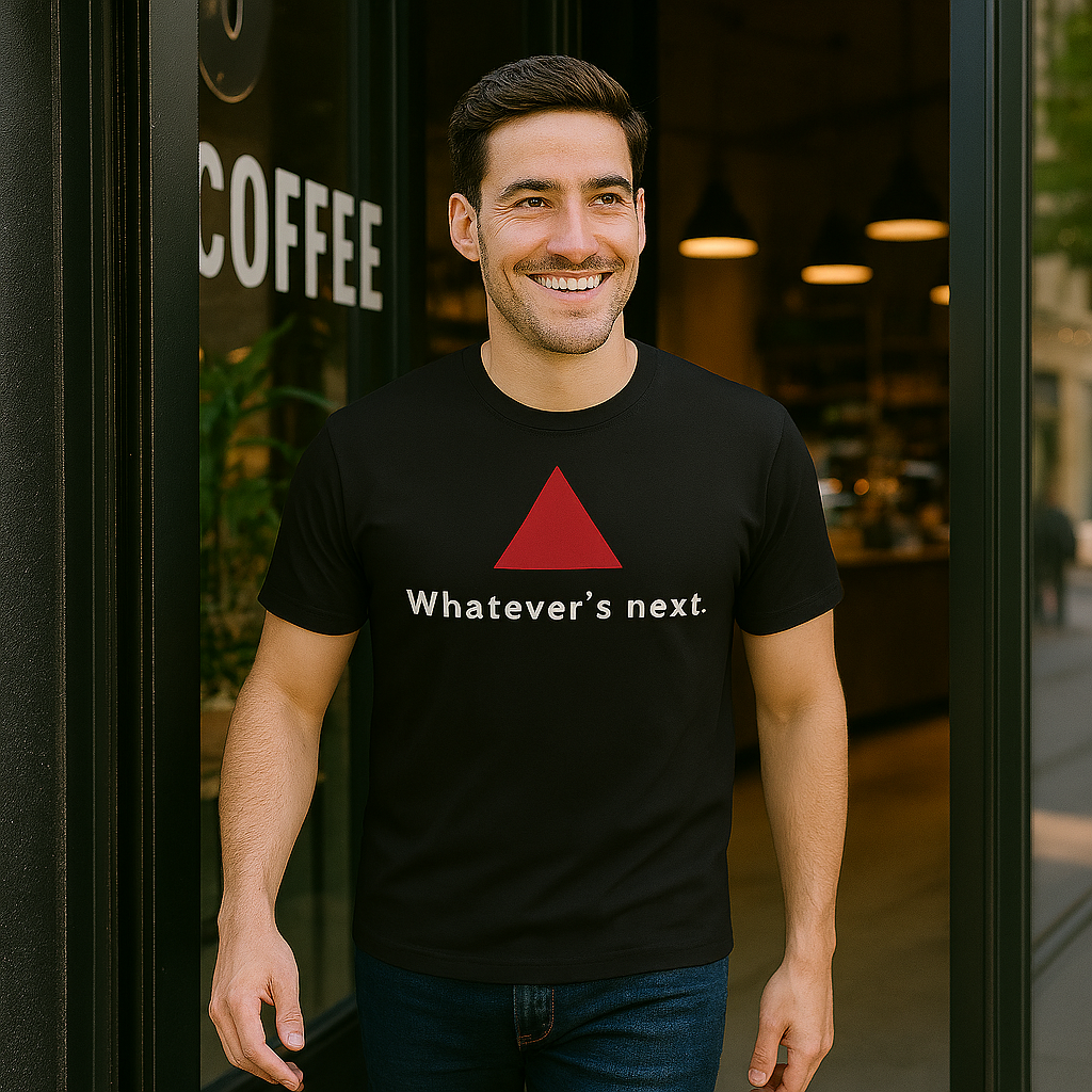 Model wearing a black t-shirt with a red triangle and text, outdoors.